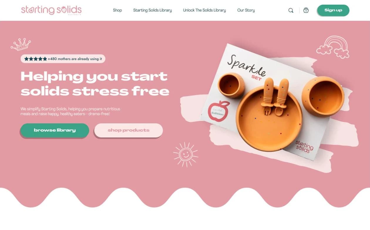 Our design for the Starting Solids homepage: Helping you start solids stress free, beside an orange plate and cutlery set on pink, with buttons to browse the library and shop products