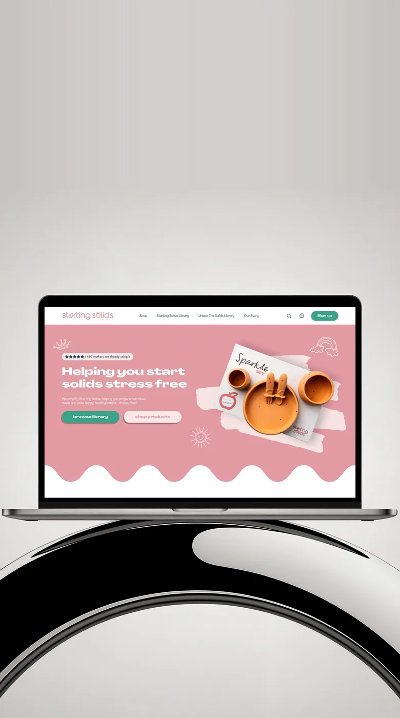 Our design for the Starting Solids homepage on a laptop: Helping you start solids stress free, on pink