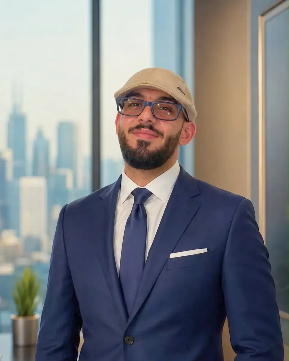 Dr. Issa Kreitem, CEO and Founder of UPAB, in a suit in front of a city view
